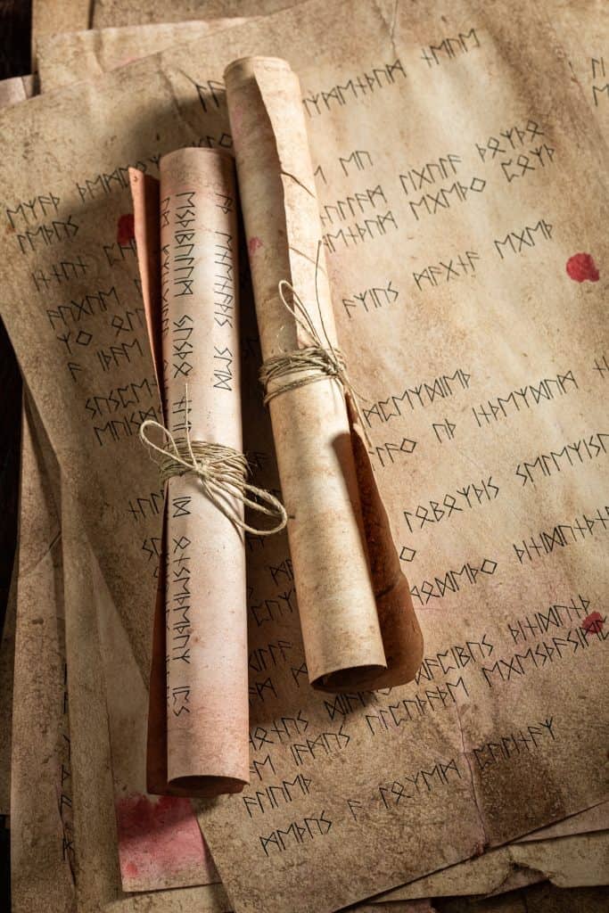 Ancient Bible manuscript with faded ink on parchment scroll, showing preserved Scripture text answering the question is the Bible reliable.